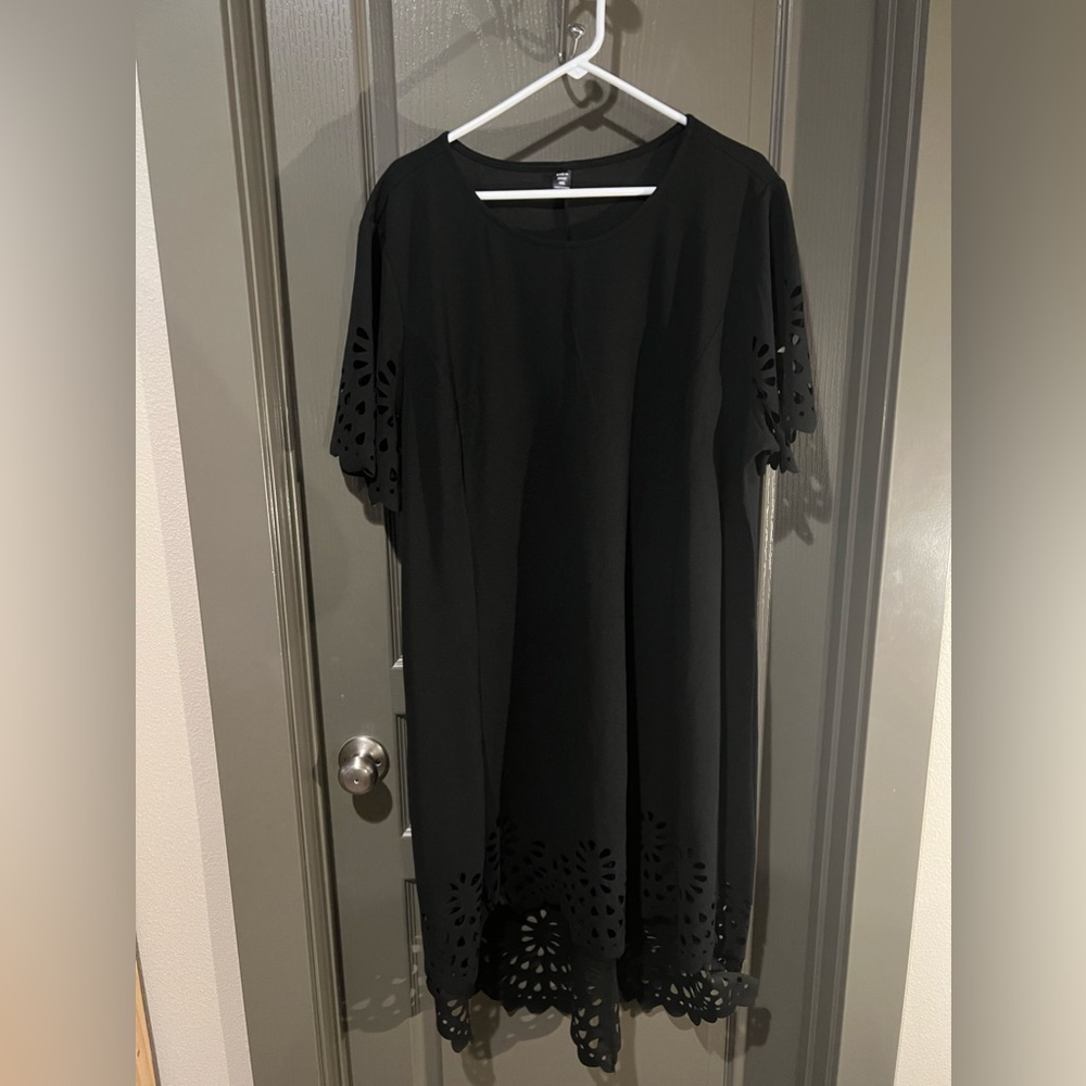 Black sheath dress with cut out detail on sleeves and hem